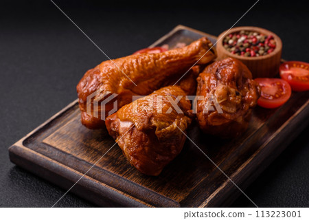 Delicious chicken legs baked on the grill with salt, spices and herbs Delicious chicken legs baked on the grill with salt, spices and herbs 113223001