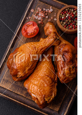 Delicious chicken legs baked on the grill with salt, spices and herbs Delicious chicken legs baked on the grill with salt, spices and herbs 113223003