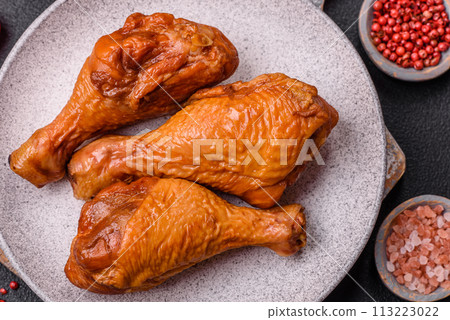 Delicious chicken legs baked on the grill with salt, spices and herbs 113223022
