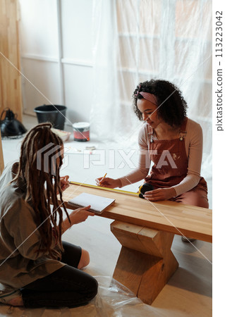 Female designers doing renovation work Female designers doing renovation work 113223042