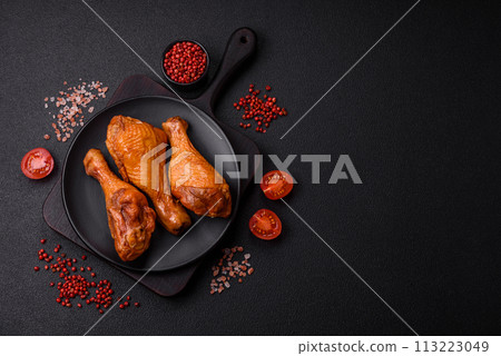 Delicious chicken legs baked on the grill with salt, spices and herbs 113223049