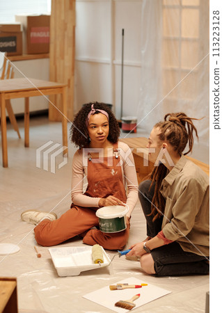 Two women doing refit work in cafe 113223128