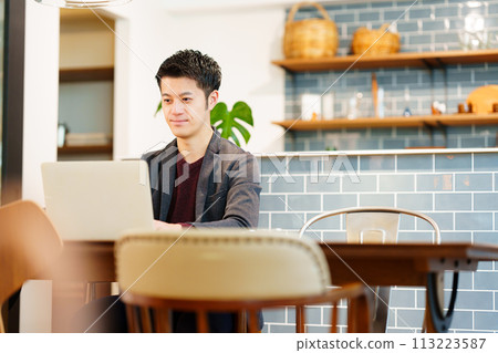 A man working at a cafe A man working at a cafe 113223587