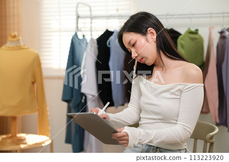 Startup small business SME, Entrepreneur owner using smartphone or tablet taking receive and checking online purchase shopping order to preparing pack product box. Selling online ideas concept 113223920