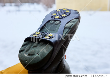 Spiked lining on sole of rubber boot will improve grip on icy surfaces in winter. Spiked lining on sole of rubber boot will improve grip on icy surfaces in winter. 113224406