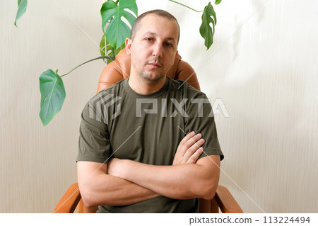 A young man suffering from depression sits in a psychologist's office. concept of mental health, psychotherapy, depression 113224494