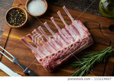 fresh lamb chop on wooden cutting board 113224607