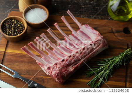fresh lamb chop on wooden cutting board fresh lamb chop on wooden cutting board 113224608