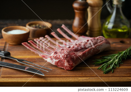 fresh lamb chop on wooden cutting board 113224609