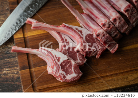 fresh lamb chop on wooden cutting board fresh lamb chop on wooden cutting board 113224610