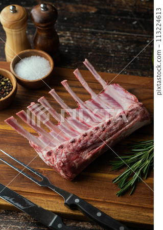 fresh lamb chop on wooden cutting board fresh lamb chop on wooden cutting board 113224613