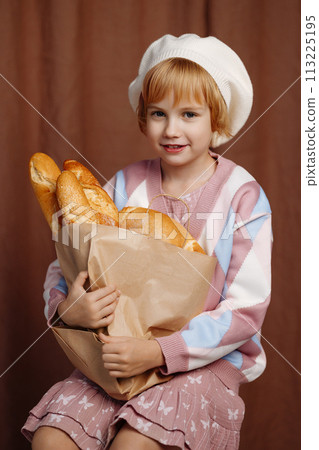 Girl holding bag full of bread. Girl holding bag full of bread. 113225195