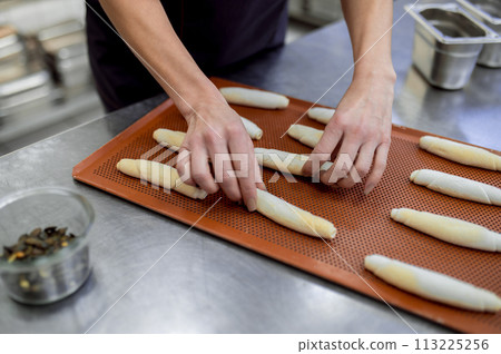 Unrecognizable woman baker producing classic croissants at bakery 113225256