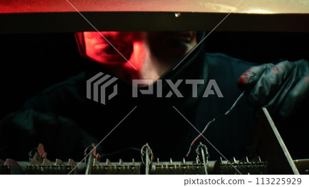 Man with balaclava forces lock on house 113225929