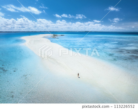 Aerial view of woman, sandbank, white sand, sea in low tide Aerial view of woman, sandbank, white sand, sea in low tide 113226552