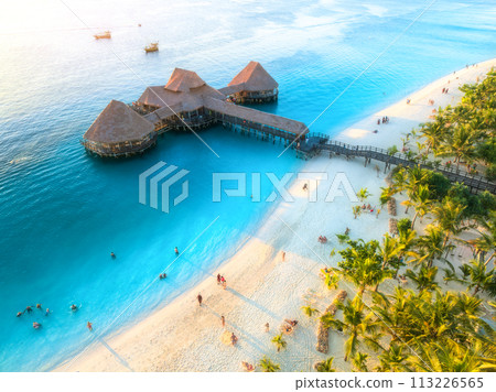 Aerial view of beautiful bungalow and sea at sunset in summer 113226565