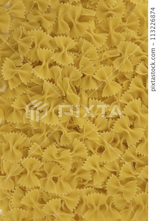 Background of raw Italian farfalle pasta close-up. Concept of pasta production. 113226874