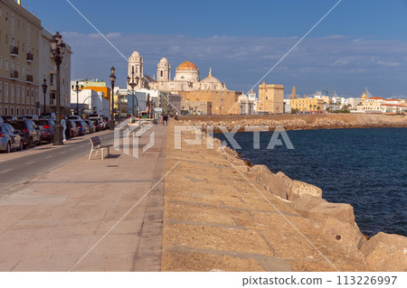 Cathedral of the Holy Cross on the Cadiz waterfront on a sunny day. 113226997