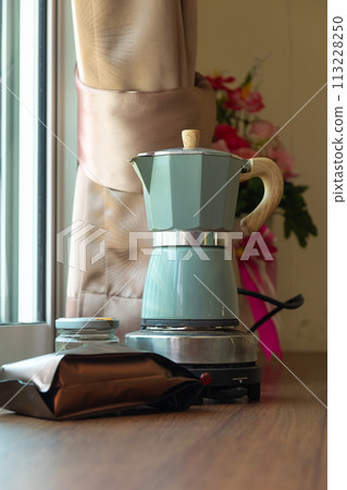 Moka Pot, Coffee pot for brewing coffee on a wooden table. Relax with a cup of coffee in the morning Moka Pot, Coffee pot for brewing coffee on a wooden table. Relax with a cup of coffee in the morning 113228250