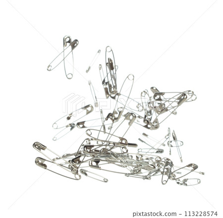 Safety Pin brooch pour fall down, explosion in air. Many safety pin small size splash fly in group floating. White background isolated high speed shutter freeze motion 113228574