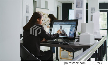 Architect reviewing residential area building plans on pc, working with interactive screen to design and outline property elements. Technician preparing for project in startup coworking space. 113229310