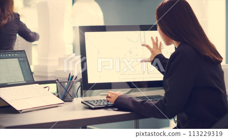 Architect designing blueprints for house remodeling project, using modern cad software on computer to create new floor plan for customers. Engineer takes measurements on layout sketches in office. Architect designing blueprints for house remodeling project, using modern cad software on computer to create new floor plan for customers. Engineer takes measurements on layout sketches in office. 113229319