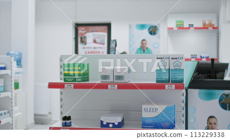 Boxes of prescribed medicine displayed in empty drugstore, awaiting clients to purchase or include under medical coverage. Pharmacy equipped with nutritional products and pharmaceutical drugs. Boxes of prescribed medicine displayed in empty drugstore, awaiting clients to purchase or include under medical coverage. Pharmacy equipped with nutritional products and pharmaceutical drugs. 113229338