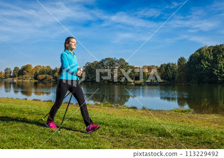 Young woman nordic walking 113229492