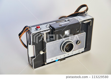 Vintage Polaroid Land Camera on Neutral Background Vintage Polaroid Land Camera on Neutral Background 113229580