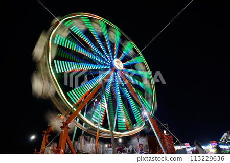 Neon Ferris Wheel Motion Blur at Night, Fairground Ambience 113229636