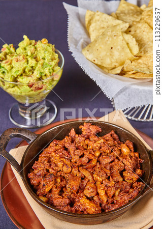 Authentic Mexican Cuisine with Grilled Meat, Guacamole, and Chips Authentic Mexican Cuisine with Grilled Meat, Guacamole, and Chips 113229657