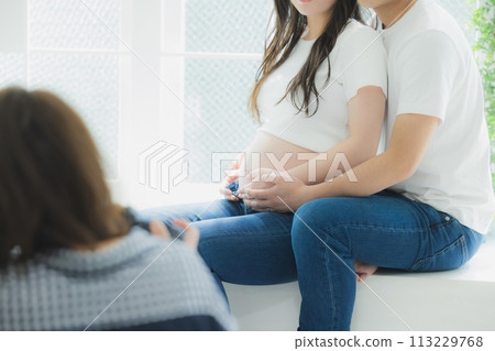 A husband supporting a pregnant woman A husband supporting a pregnant woman 113229768