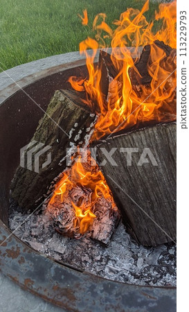 Campfire Glow with Fiery Logs and Embers, Outdoor Setting 113229793