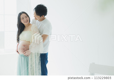 A husband supporting a pregnant woman A husband supporting a pregnant woman 113229803