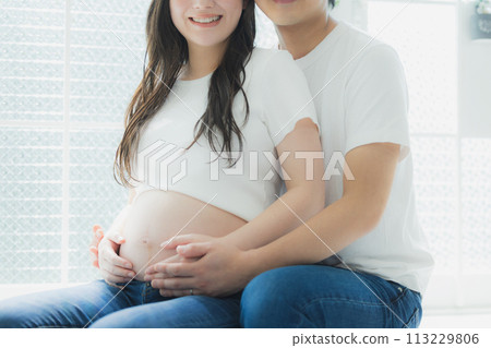 A husband supporting a pregnant woman 113229806