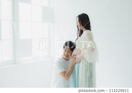 A husband supporting a pregnant woman 113229811