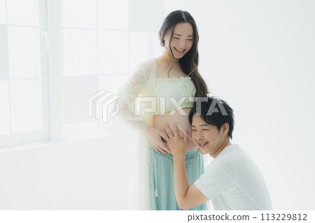 A husband supporting a pregnant woman A husband supporting a pregnant woman 113229812