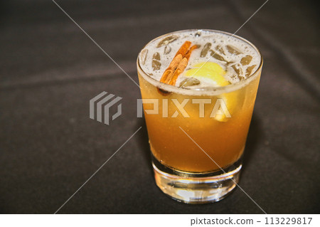 Craft Cocktail with Cinnamon and Lemon Garnish Close-Up Craft Cocktail with Cinnamon and Lemon Garnish Close-Up 113229817