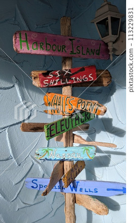 Tropical Signpost with Directional Arrows and Coastal Lamp Tropical Signpost with Directional Arrows and Coastal Lamp 113229831