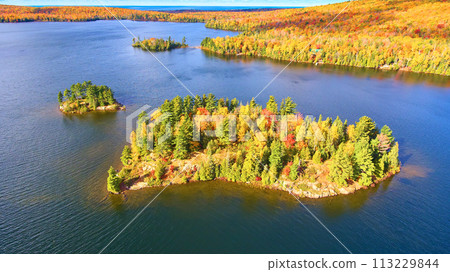 Aerial Autumn Splendor Over Serene Lake and Forested Island Aerial Autumn Splendor Over Serene Lake and Forested Island 113229844