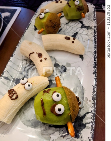 Playful Banana and Kiwi Fruit Characters on Plate 113229852