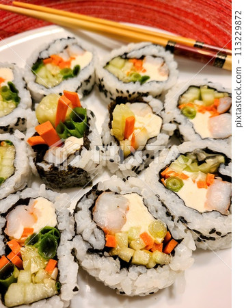 Fresh Sushi Variety on White Plate with Chopsticks - Home Cooked Japanese Cuisine Fresh Sushi Variety on White Plate with Chopsticks - Home Cooked Japanese Cuisine 113229872