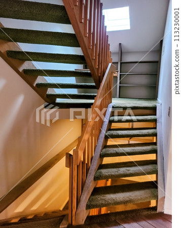 Cozy Green Carpeted Staircase with Wooden Banister in Sunlit Home Interior Cozy Green Carpeted Staircase with Wooden Banister in Sunlit Home Interior 113230001
