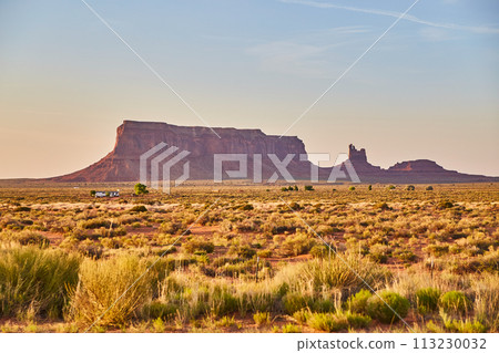 Golden Hour in Monument Valley with Desert Road and Vegetation Golden Hour in Monument Valley with Desert Road and Vegetation 113230032
