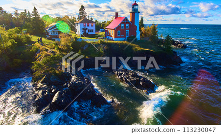Aerial View of Eagle Harbor Lighthouse and Coastal Homes 113230047