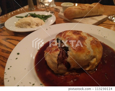 Gourmet Beef Wellington with Sides on Restaurant Table 113230114