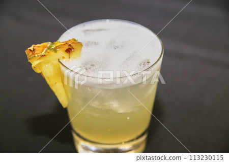 Fresh Citrus Cocktail with Pineapple Garnish in Bar 113230115