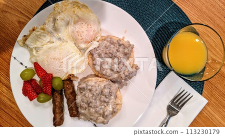 Hearty American Breakfast Plate with Fresh Fruit and Juice Hearty American Breakfast Plate with Fresh Fruit and Juice 113230179