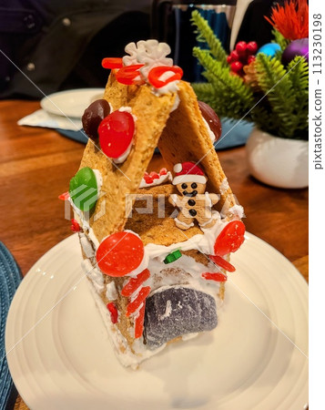 Festive Gingerbread House with Colorful Candies and Icing Close-Up Festive Gingerbread House with Colorful Candies and Icing Close-Up 113230198