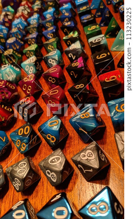 Colorful Polyhedral Dice Collection on Wooden Surface Close-Up 113230225